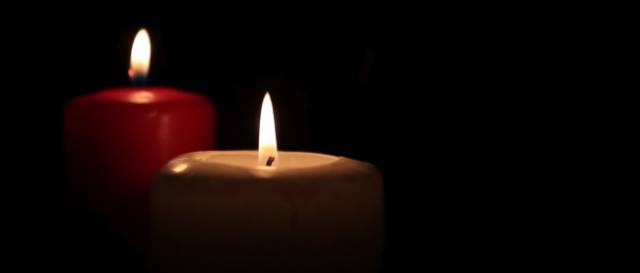stock-footage-close-up-of-two-candles-burn-against-a-black-background.jpg