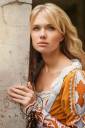 60901155-beautiful-blond-woman-in-medieval-dress-walking-near-old-building.jpg